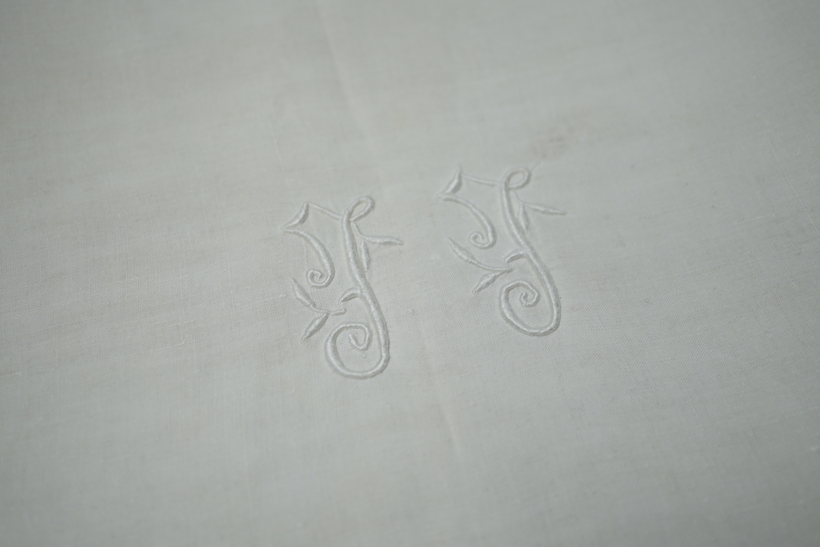A French monogrammed linen refectory tablecloth and twelve matching dinner size napkins